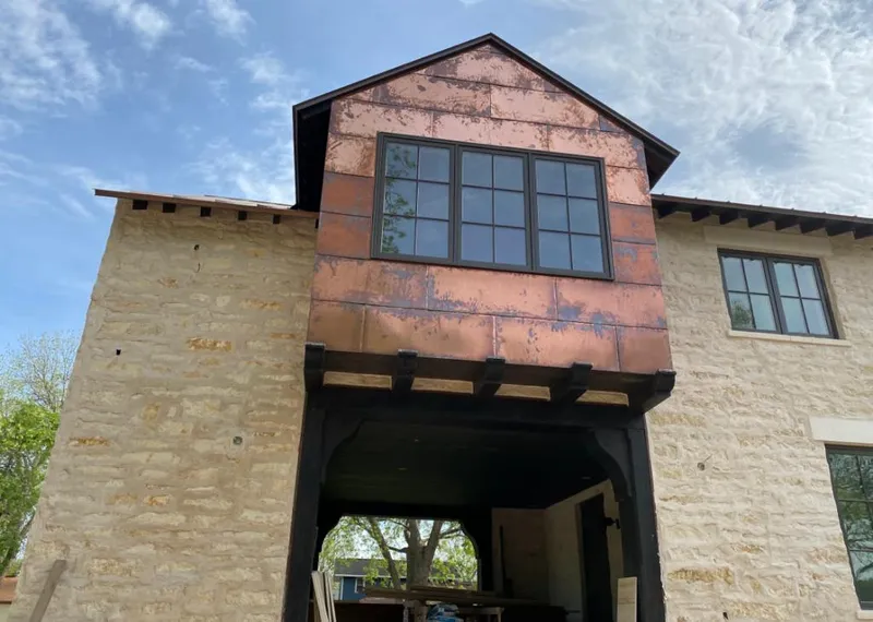 Copper metal panel facade on a stone building for Skylight Installation in Plumas Lake